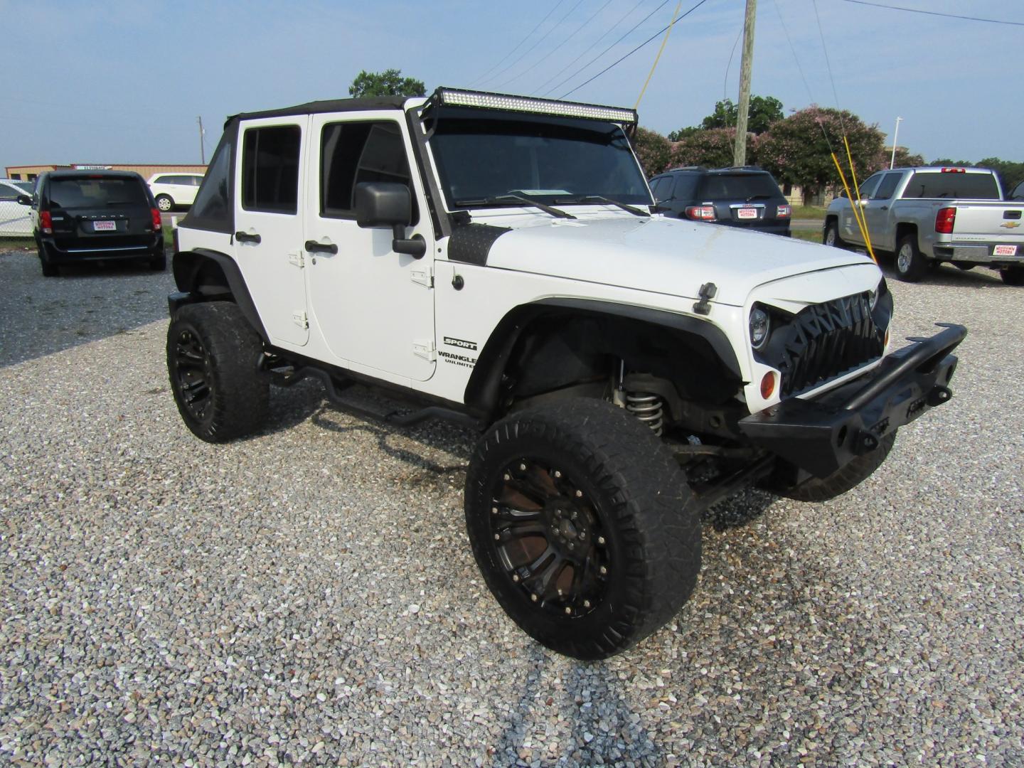 2011 White /Black Jeep Wrangler Unlimited Sport 4WD (1J4BA3H18BL) with an 3.8L V6 OHV 12V engine, Automatic transmission, located at 15016 S Hwy 231, Midland City, AL, 36350, (334) 983-3001, 31.306210, -85.495277- Photo#0