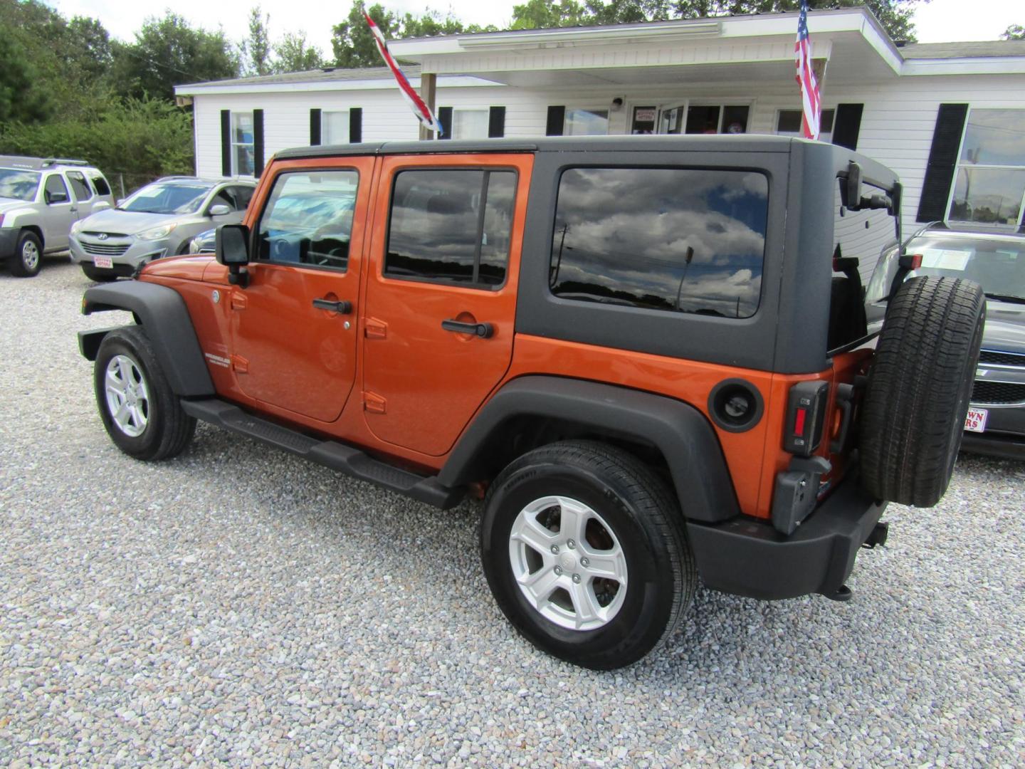 2011 Orange /Black Jeep Wrangler Unlimited Sport 4WD (1J4BA3H16BL) with an 3.8L V6 OHV 12V engine, Automatic transmission, located at 15016 S Hwy 231, Midland City, AL, 36350, (334) 983-3001, 31.306210, -85.495277 - Photo#5