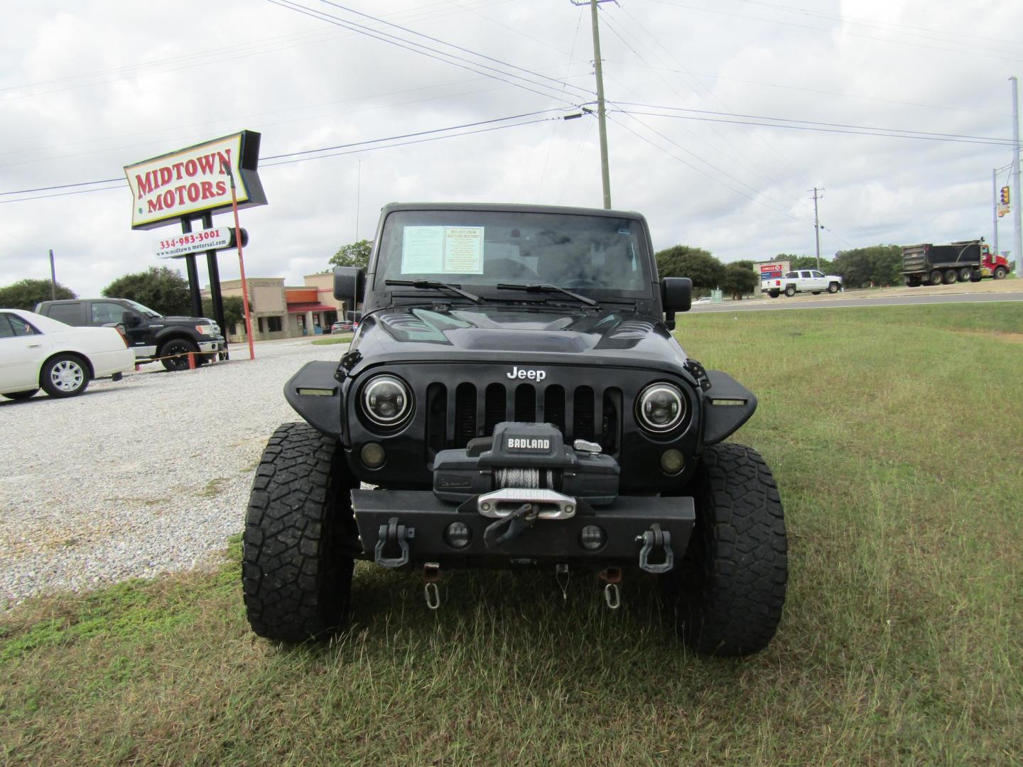 2014 Black Jeep Wrangler Unlimited Sport 4WD (1C4BJWDG7EL) with an 3.6L V6 DOHC 24V FFV engine, Automatic transmission, located at 15016 S Hwy 231, Midland City, AL, 36350, (334) 983-3001, 31.306210, -85.495277 - Photo#1