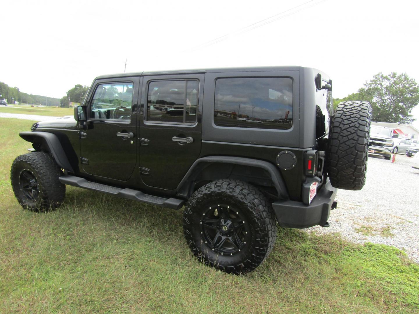 2014 Black Jeep Wrangler Unlimited Sport 4WD (1C4BJWDG7EL) with an 3.6L V6 DOHC 24V FFV engine, Automatic transmission, located at 15016 S Hwy 231, Midland City, AL, 36350, (334) 983-3001, 31.306210, -85.495277 - Photo#4