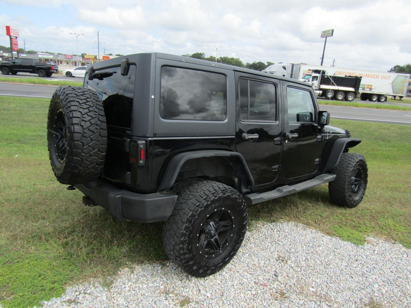 2014 Black Jeep Wrangler Unlimited Sport 4WD (1C4BJWDG7EL) with an 3.6L V6 DOHC 24V FFV engine, Automatic transmission, located at 15016 S Hwy 231, Midland City, AL, 36350, (334) 983-3001, 31.306210, -85.495277 - Photo#5