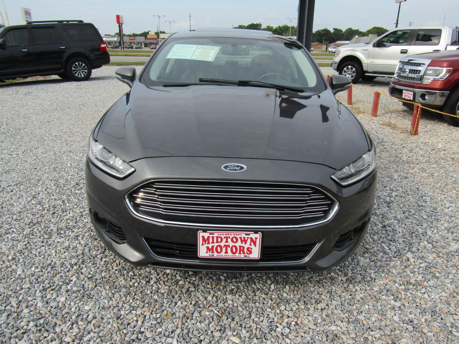2016 Gray Ford Fusion Titanium (3FA6P0K97GR) with an 2.0L L4 DOHC 16V engine, Automatic transmission, located at 15016 S Hwy 231, Midland City, AL, 36350, (334) 983-3001, 31.306210, -85.495277 - Photo #1