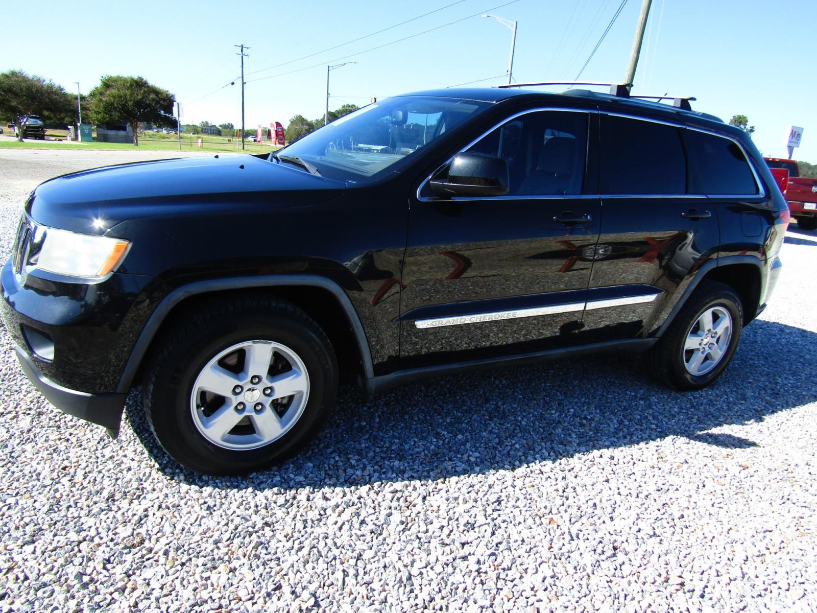 2012 Black /Tan Jeep Grand Cherokee Laredo 2WD (1C4RJEAG2CC) with an 3.6L V6 DOHC 24V engine, Automatic transmission, located at 15016 S Hwy 231, Midland City, AL, 36350, (334) 983-3001, 31.306210, -85.495277 - Photo #2