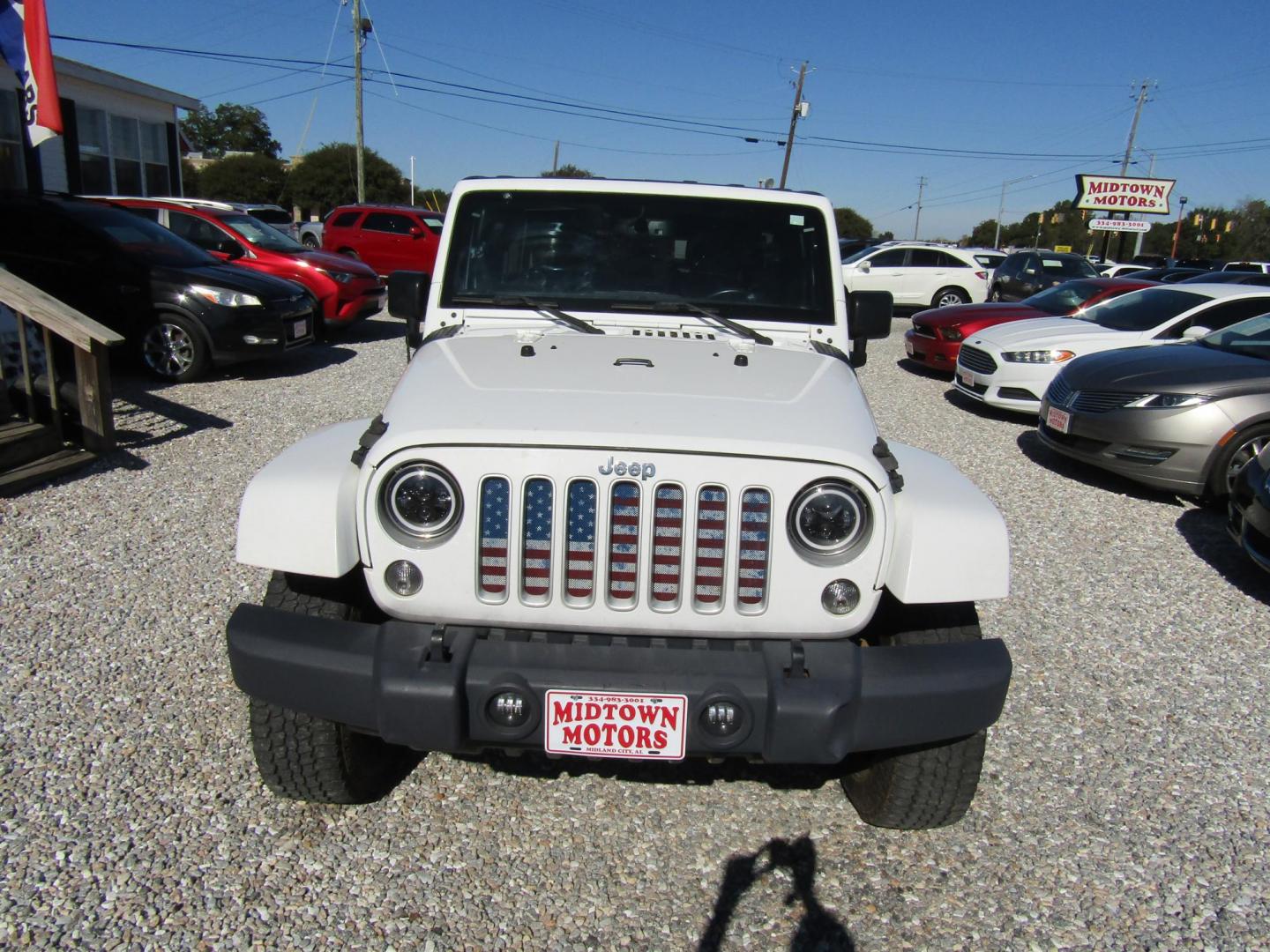 2016 White Jeep Wrangler Unlimited Sahara 4WD (1C4BJWEG9GL) with an 3.6L V6 DOHC 24V FFV engine, Automatic transmission, located at 15016 S Hwy 231, Midland City, AL, 36350, (334) 983-3001, 31.306210, -85.495277 - Photo#1
