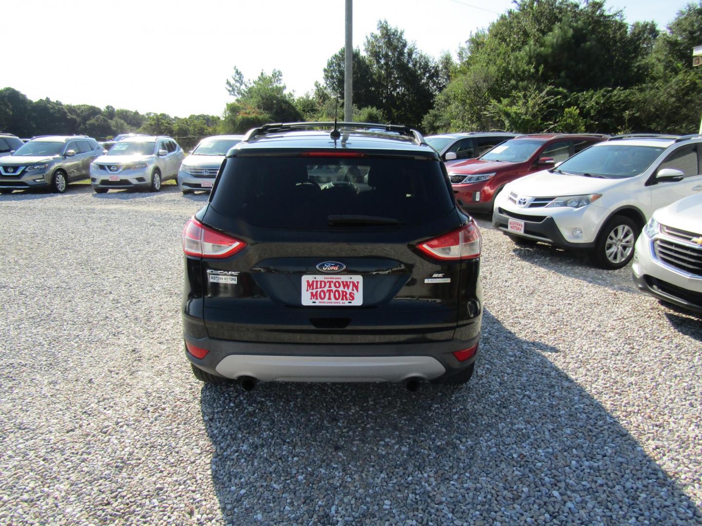 2013 Black Ford Escape SE FWD (1FMCU0GX9DU) with an 1.6L L4 DOHC 16V engine, Automatic transmission, located at 15016 S Hwy 231, Midland City, AL, 36350, (334) 983-3001, 31.306210, -85.495277 - Photo#6