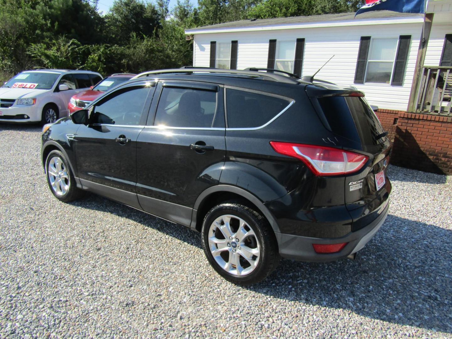 2013 Black Ford Escape SE FWD (1FMCU0GX9DU) with an 1.6L L4 DOHC 16V engine, Automatic transmission, located at 15016 S Hwy 231, Midland City, AL, 36350, (334) 983-3001, 31.306210, -85.495277 - Photo#5