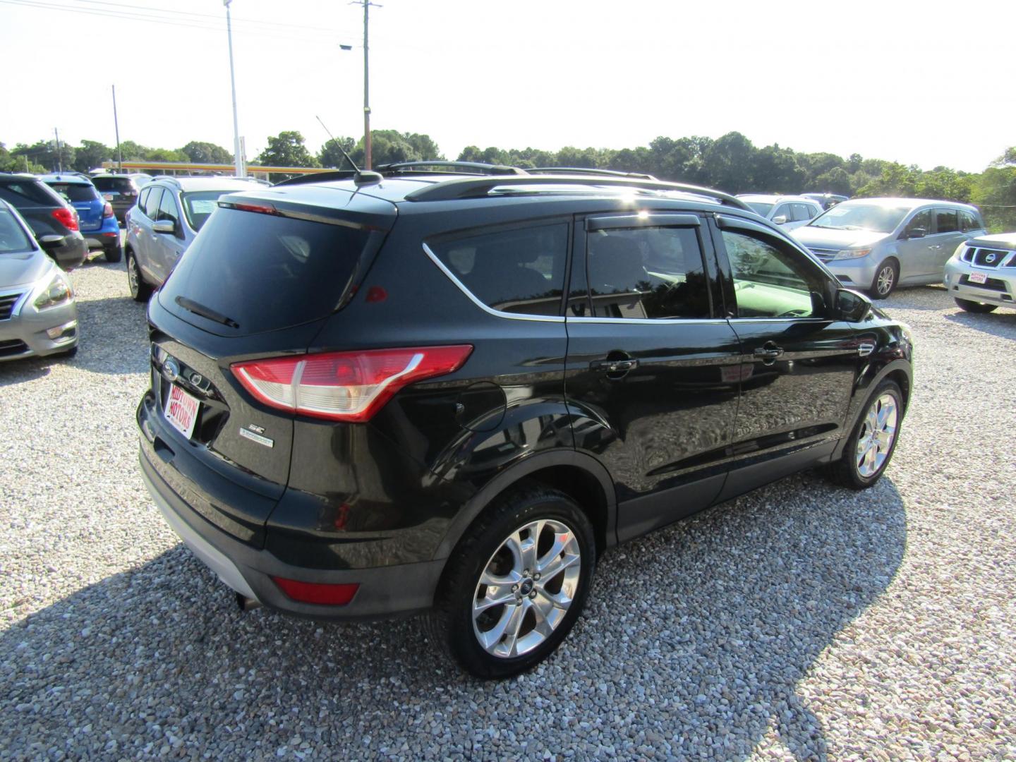 2013 Black Ford Escape SE FWD (1FMCU0GX9DU) with an 1.6L L4 DOHC 16V engine, Automatic transmission, located at 15016 S Hwy 231, Midland City, AL, 36350, (334) 983-3001, 31.306210, -85.495277 - Photo#7