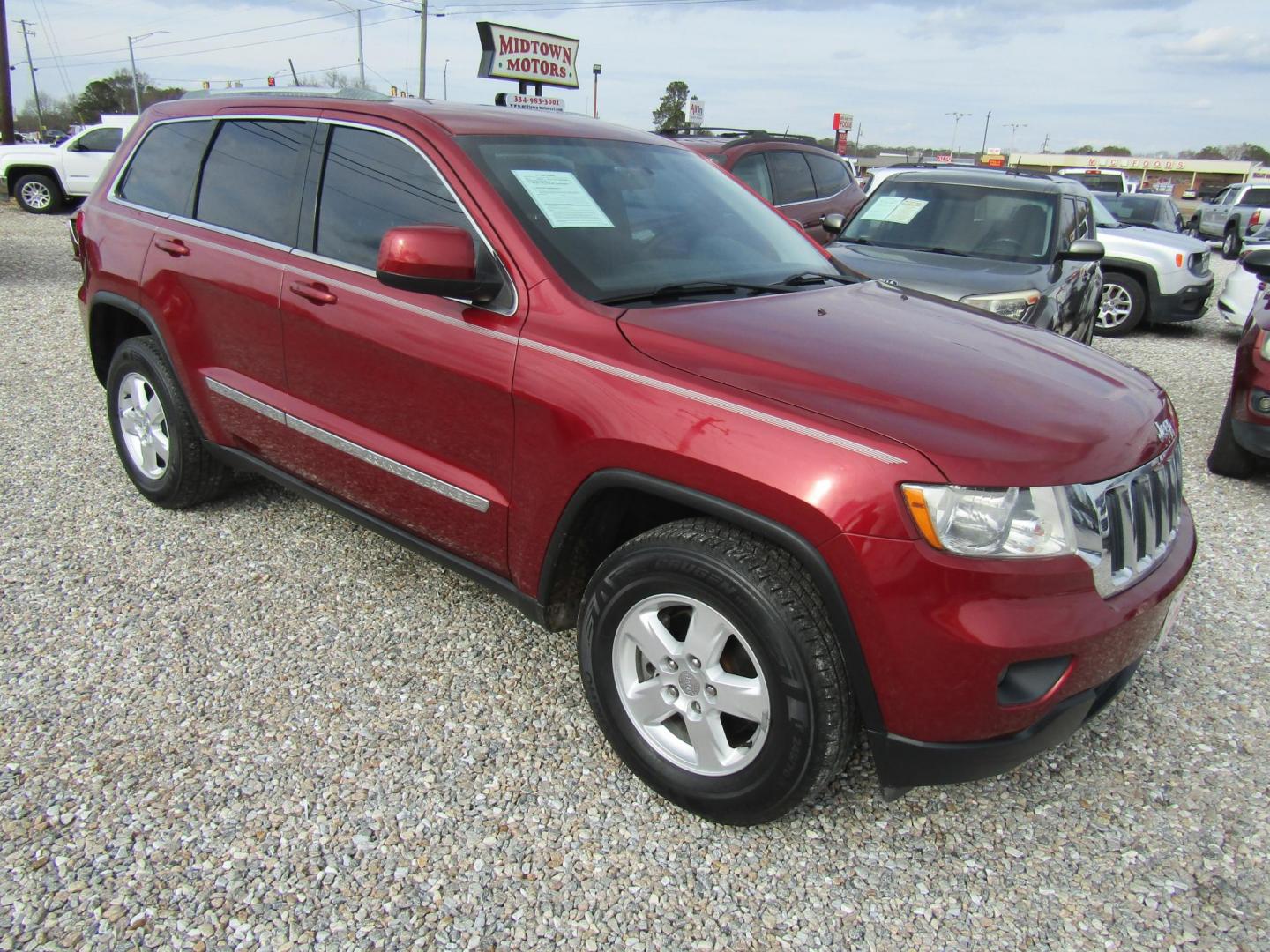 2012 Red Jeep Grand Cherokee Laredo 2WD (1C4RJEAGXCC) with an 3.6L V6 DOHC 24V engine, Automatic transmission, located at 15016 S Hwy 231, Midland City, AL, 36350, (334) 983-3001, 31.306210, -85.495277 - Photo#0