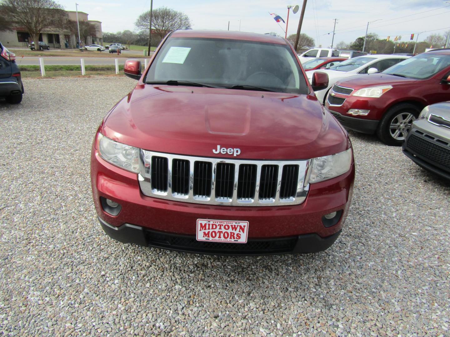 2012 Red Jeep Grand Cherokee Laredo 2WD (1C4RJEAGXCC) with an 3.6L V6 DOHC 24V engine, Automatic transmission, located at 15016 S Hwy 231, Midland City, AL, 36350, (334) 983-3001, 31.306210, -85.495277 - Photo#1