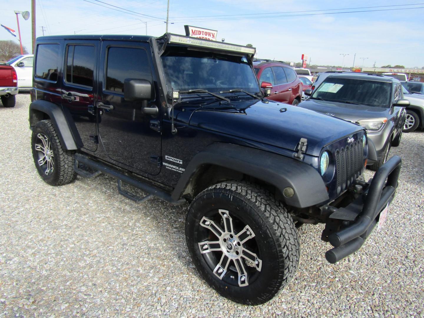 2013 Blue Jeep Wrangler Unlimited Sport 4WD (1C4BJWDGXDL) with an 3.6L V6 DOHC 24V FFV engine, Automatic transmission, located at 15016 S Hwy 231, Midland City, AL, 36350, (334) 983-3001, 31.306210, -85.495277 - Photo#0